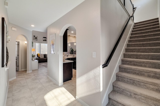 stairway with tile patterned floors