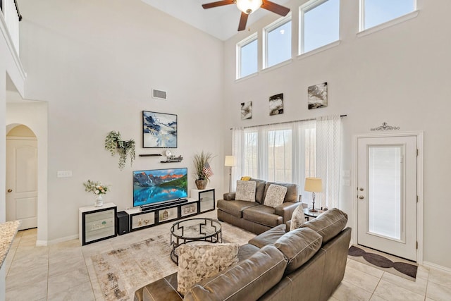 tiled living room with ceiling fan