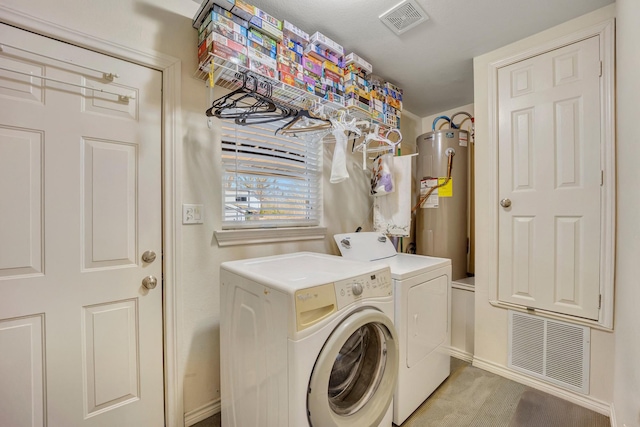 laundry room featuring separate washer and dryer, light colored carpet, and water heater