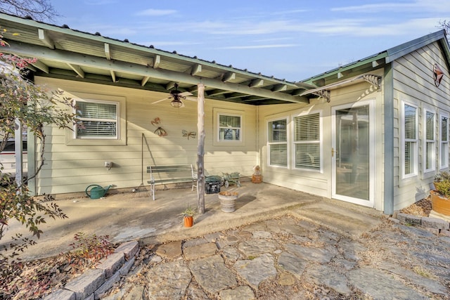 back of house with ceiling fan and a patio area