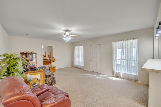 living room with ceiling fan and carpet flooring