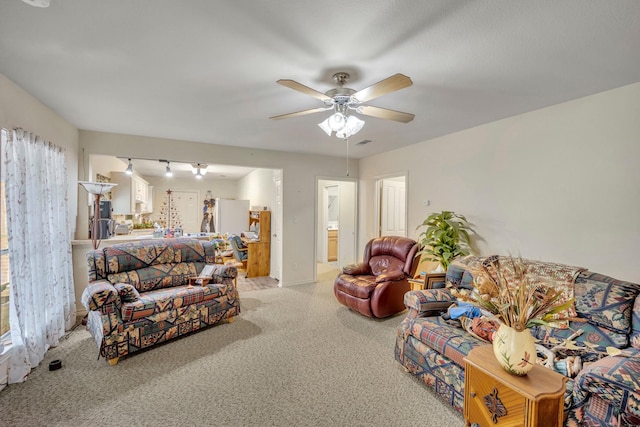 bedroom with ceiling fan, ensuite bath, refrigerator, and carpet