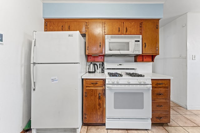 kitchen featuring light tile patterned floors and white appliances