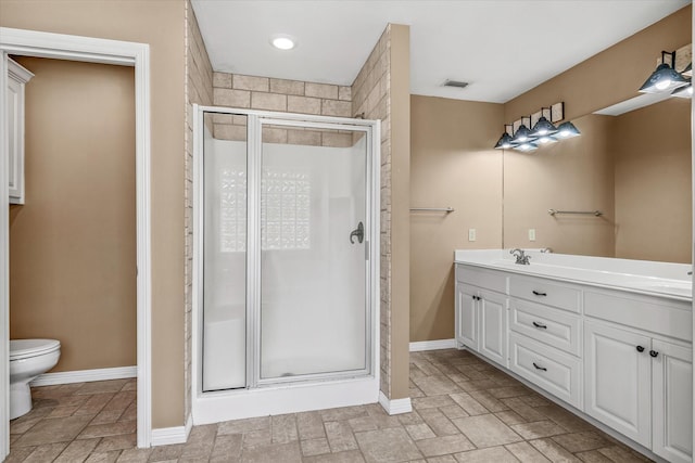 bathroom featuring vanity, toilet, and an enclosed shower