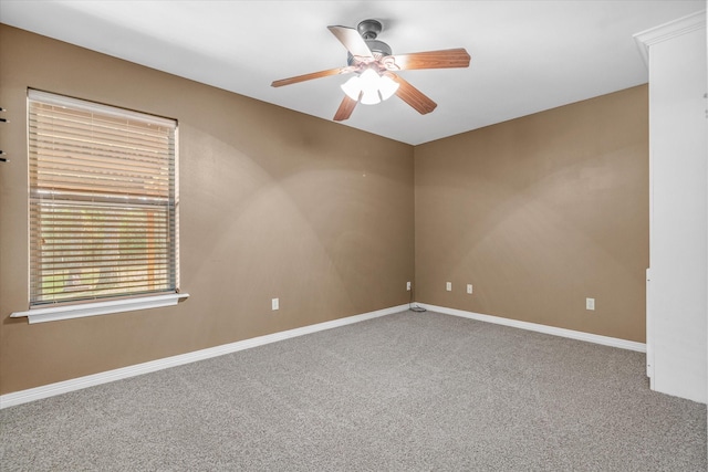 spare room featuring ceiling fan and carpet