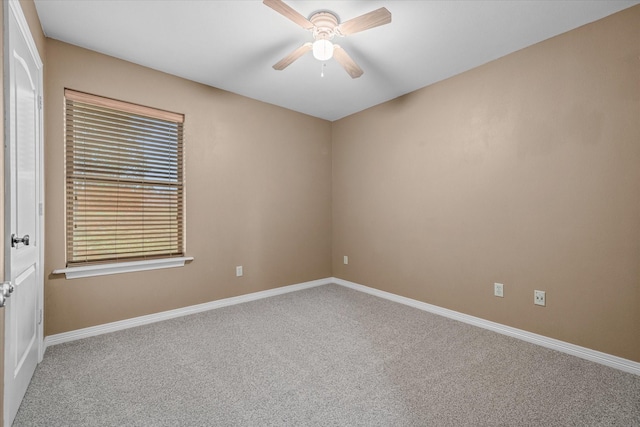 spare room with ceiling fan and carpet