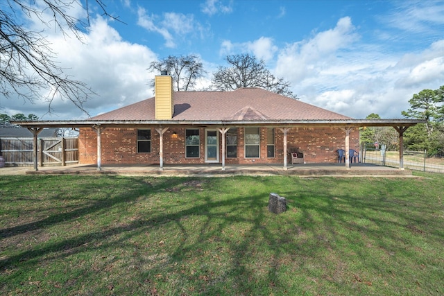 back of property featuring a lawn and a patio area