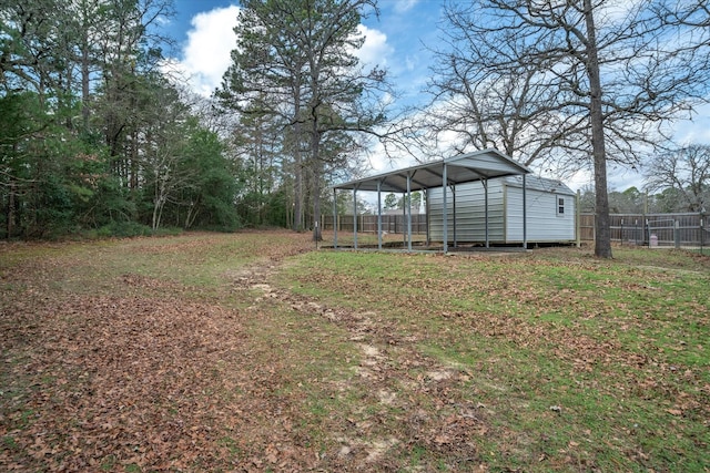 view of yard featuring a carport and a shed