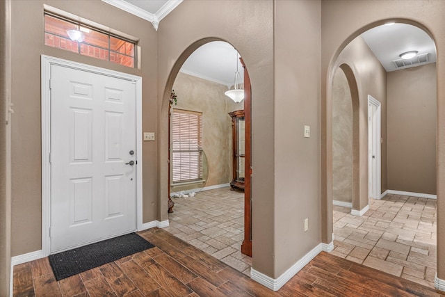 entryway featuring crown molding and hardwood / wood-style flooring