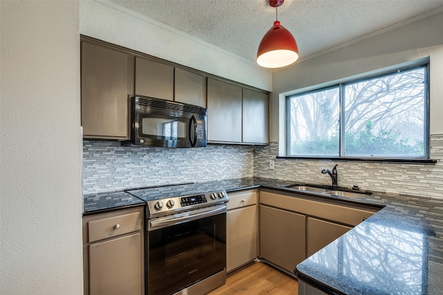 kitchen with sink, stainless steel electric range, light hardwood / wood-style flooring, pendant lighting, and decorative backsplash