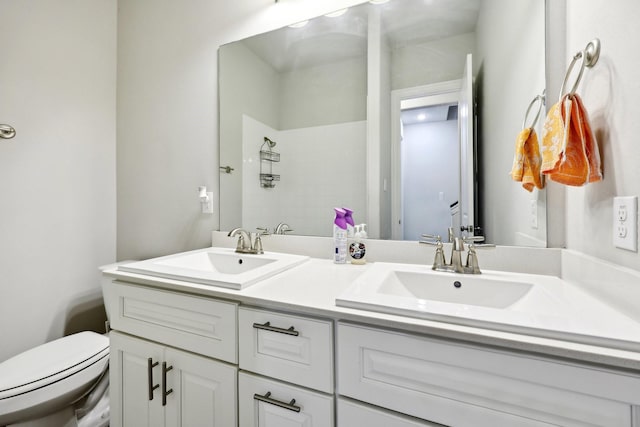 bathroom with vanity, a shower, and toilet