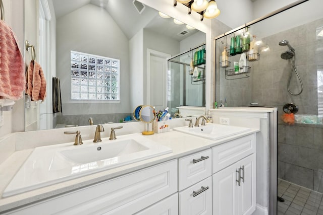 bathroom featuring lofted ceiling, an enclosed shower, and vanity