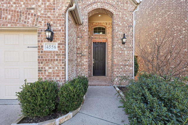 view of exterior entry featuring a garage