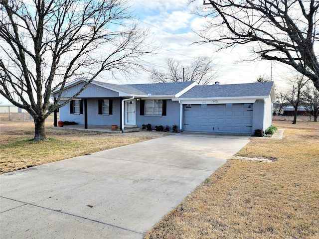 ranch-style home with a garage and a front yard