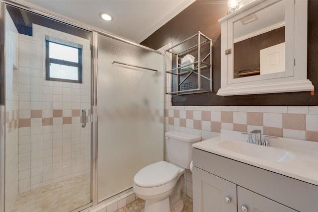 bathroom featuring tile walls, an enclosed shower, vanity, and toilet