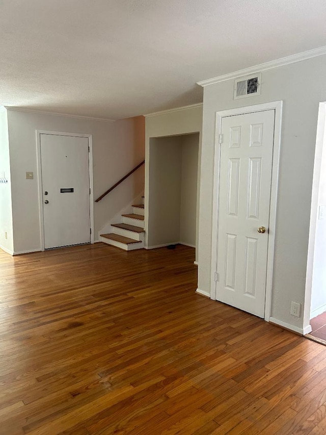 interior space with hardwood / wood-style flooring and crown molding