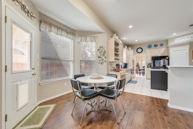 dining room featuring sink and light wood-type flooring