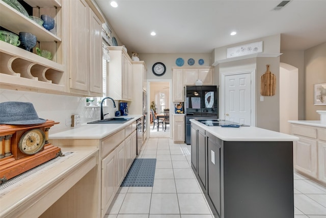 kitchen with sink, light tile patterned floors, dishwasher, a kitchen island, and decorative backsplash