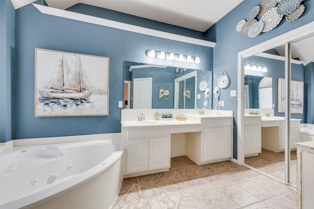 bathroom featuring tile patterned floors, vanity, and a tub