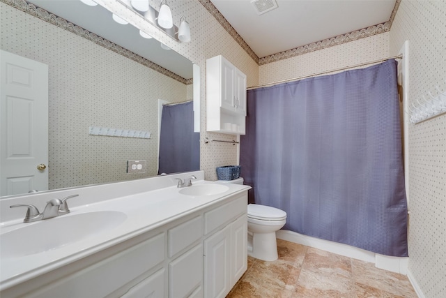 bathroom featuring walk in shower, vanity, and toilet