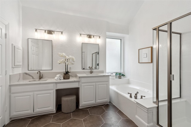 bathroom featuring vaulted ceiling, vanity, plus walk in shower, and tile patterned flooring