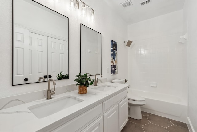 full bathroom with vanity, tile patterned floors, toilet, and shower / washtub combination