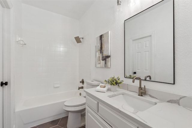 full bathroom with tile patterned flooring, vanity, tiled shower / bath combo, and toilet