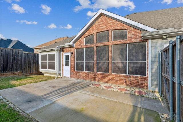 back of house with a patio