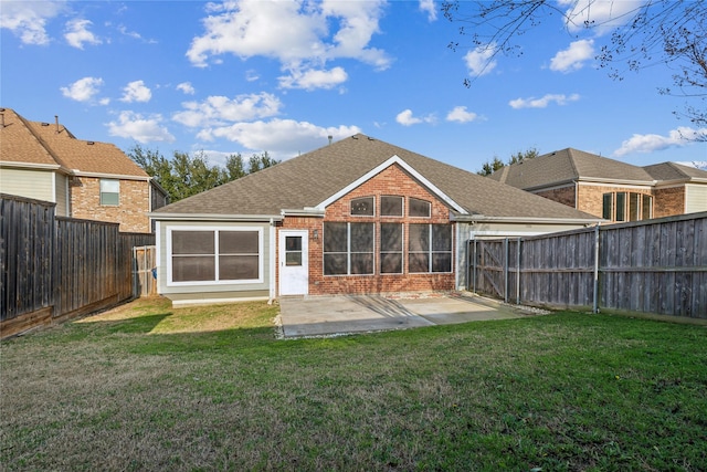 rear view of house with a patio area and a lawn