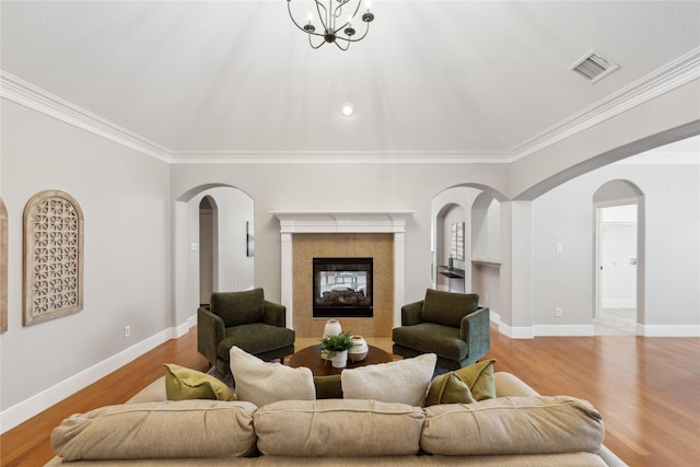 living room with ornamental molding and light hardwood / wood-style flooring