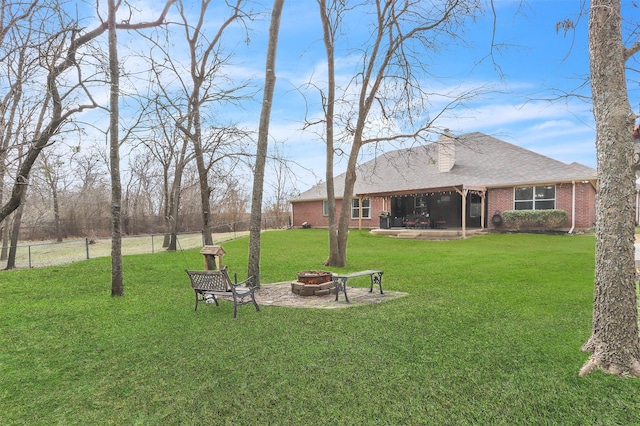 view of yard with a patio and an outdoor fire pit