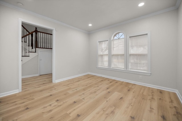 unfurnished room featuring ornamental molding and light wood-type flooring