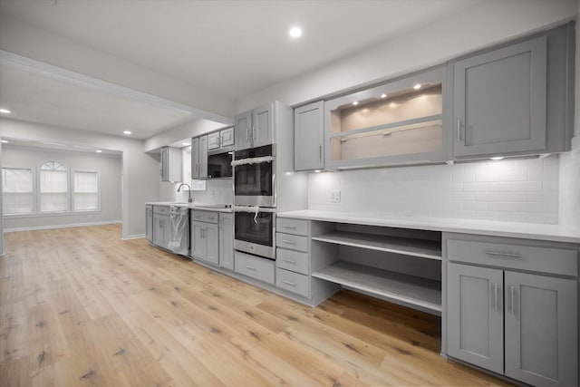 kitchen featuring gray cabinets, light hardwood / wood-style floors, and stainless steel appliances