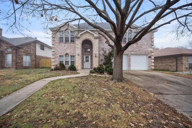 view of front of home with a garage and a front lawn