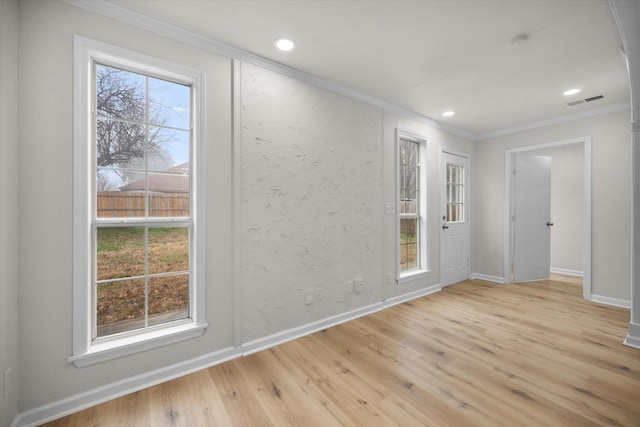 interior space featuring crown molding and light wood-type flooring