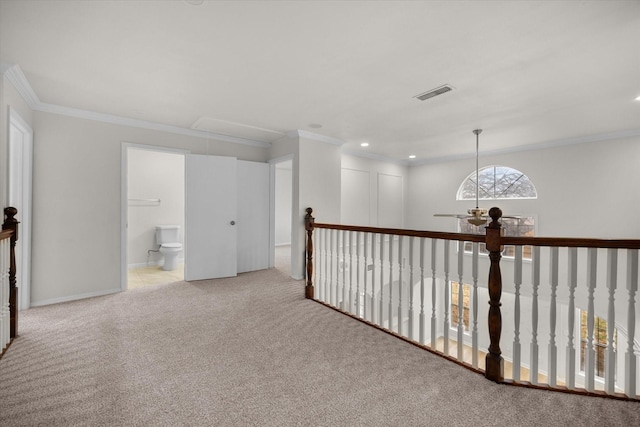 corridor with light carpet and crown molding