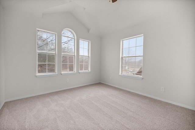 empty room with lofted ceiling and carpet