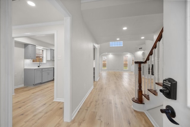 corridor featuring sink and light hardwood / wood-style floors