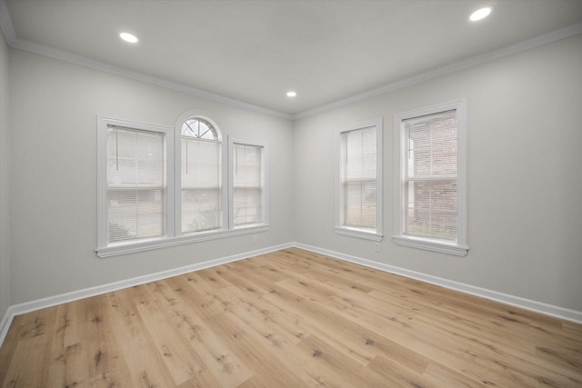 unfurnished room featuring crown molding and light wood-type flooring