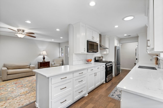 kitchen featuring sink, backsplash, white cabinets, light stone counters, and stainless steel appliances