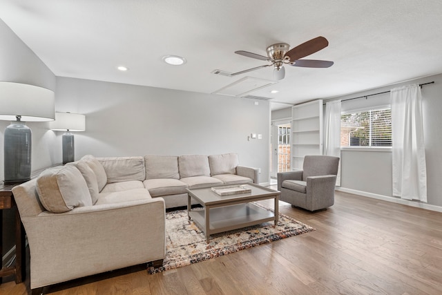 living room with hardwood / wood-style floors and ceiling fan