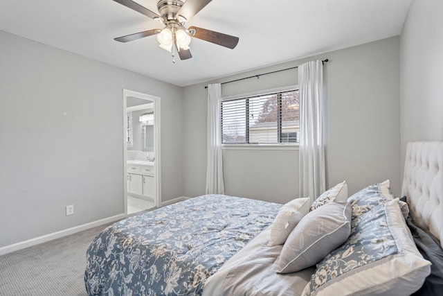 carpeted bedroom featuring ensuite bathroom, sink, and ceiling fan