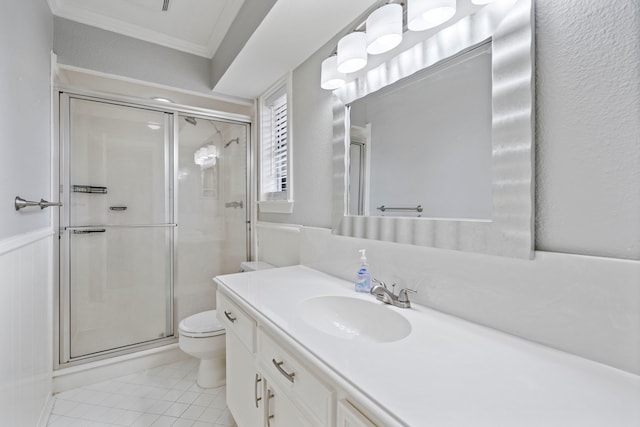 bathroom with tile patterned floors, toilet, an enclosed shower, ornamental molding, and vanity