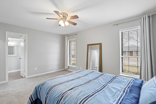 bedroom featuring multiple windows, light carpet, and ceiling fan