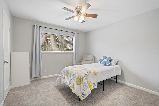 bedroom featuring ceiling fan and light carpet