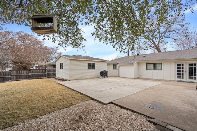 back of property with a patio area and a lawn