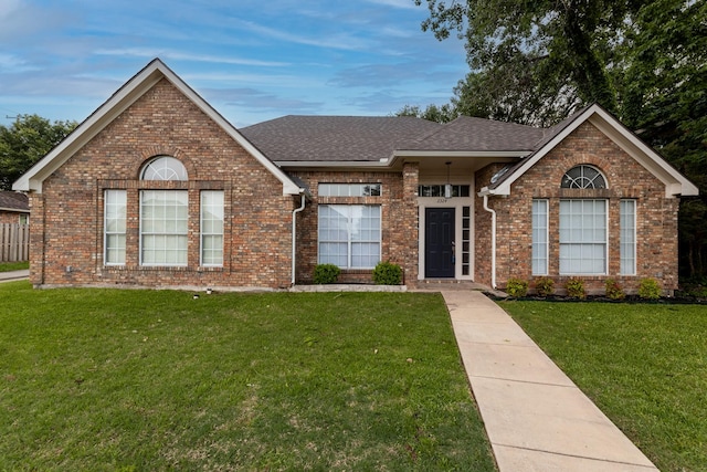 2324 Spring Mills Rd, Mesquite, TX 75181 - ranch-style house with brick siding, a shingled roof, and a front lawn