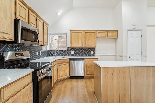 kitchen with appliances with stainless steel finishes, high vaulted ceiling, sink, backsplash, and light wood-type flooring