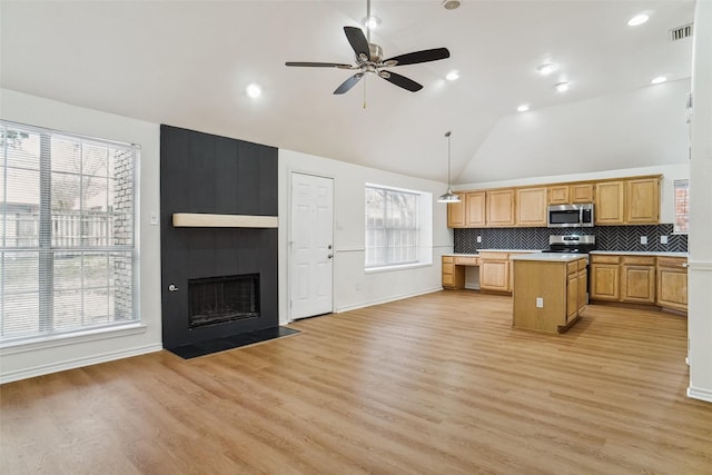 2324 Spring Mills Rd, Mesquite, TX 75181 - kitchen with visible vents, a healthy amount of sunlight, a center island, light countertops, and stainless steel appliances