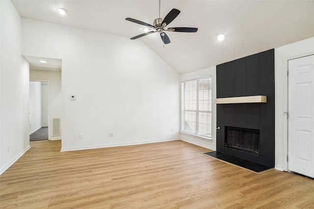 2324 Spring Mills Rd, Mesquite, TX 75181 - unfurnished living room with light wood-style floors, baseboards, ceiling fan, and a fireplace